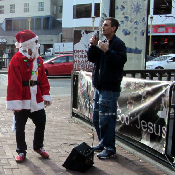 SANTA HECKLES MIKE AT 5TH ST. AND MARKET.