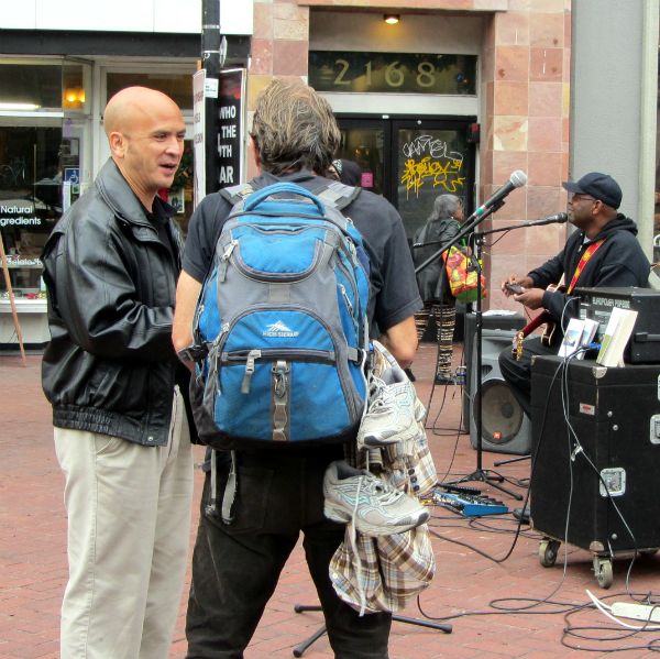 BROTHER &quot;G&quot; WITNESSES TO A MAN WHILE RICHARD GRIFFIN SINGS IN DOWNTOWN BERKELEY.