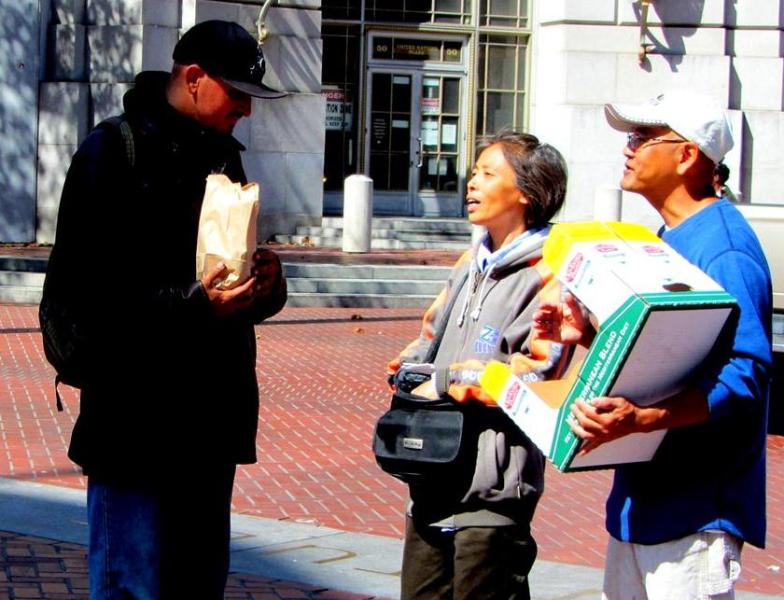 May and Loi give out food at UN Plaza. 