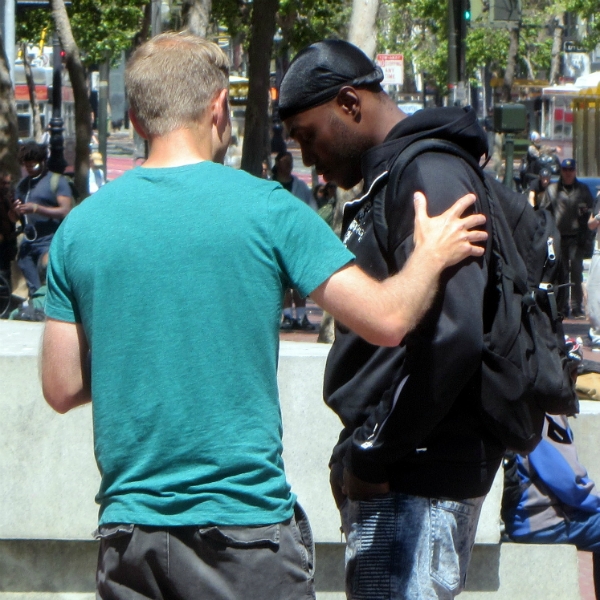 CAL PRAYS FOR MAN AT UN PLAZA.