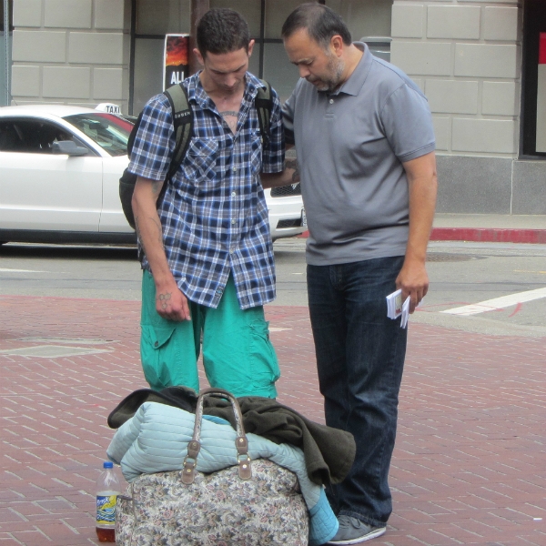 JESSE PRAYS WITH MAN IN BERKELEY.