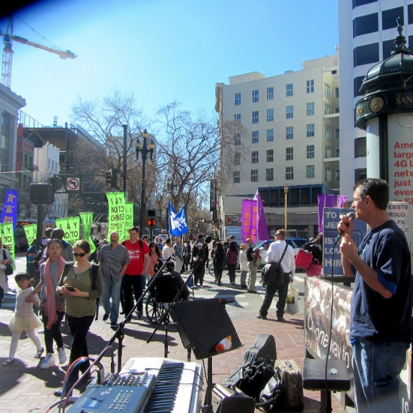 MIKE PREACHES AS FALUN GONG MARCH PASSES US AT 5TH AND MARKET.