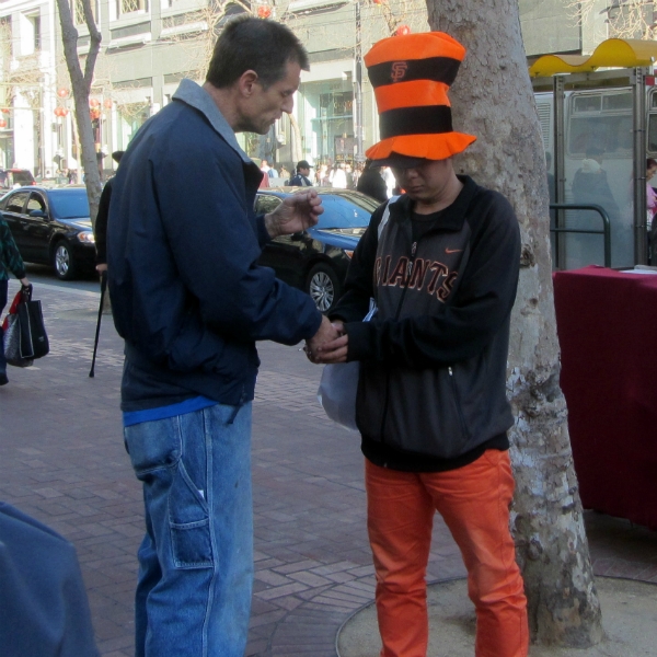 MIKE PRAYS WITH MAN AT 5TH AND MARKET.