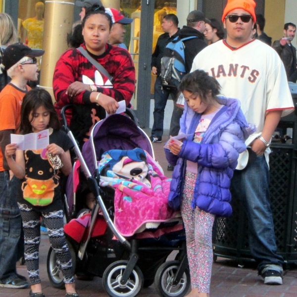 GIRLS READ GOSPEL TRACTS AT POWELL AND MARKET.