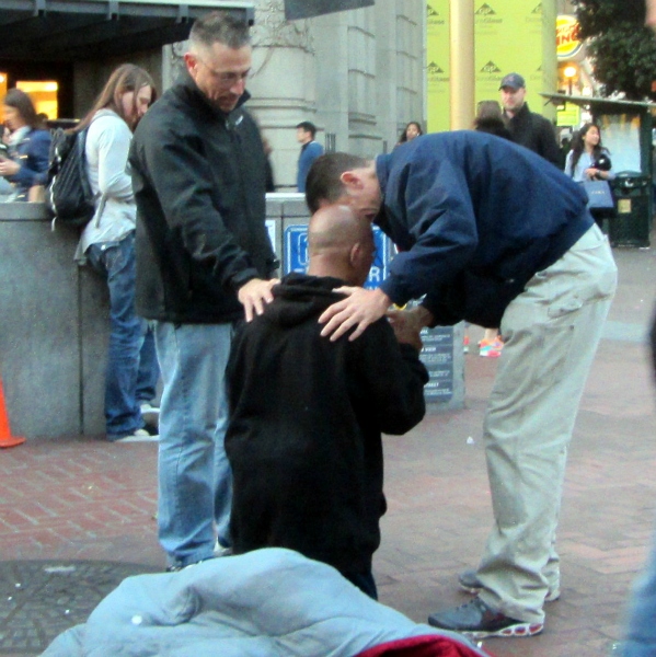 BILL AND MIKE PRAY WITH MAN AT POWELL AND MARKET.