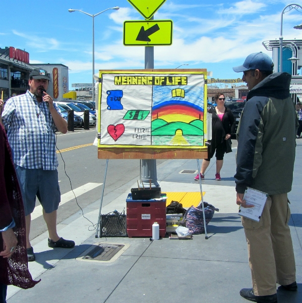 DAN PREACHES WITH SKETCHBOARD AT FISHERMAN'S WHARF.