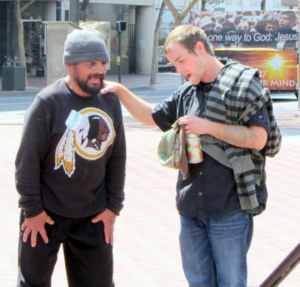 Eddie prays with man at UN Plaza