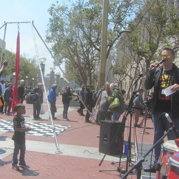 ADAM PREACHES AT UN PLAZA.