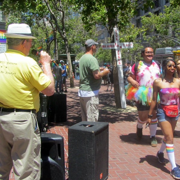 SCOTT PREACHES AT SEAN PASSES OUT TRACTS AT 5TH & MARKET THE DAY BEFORE GAY PARADE.