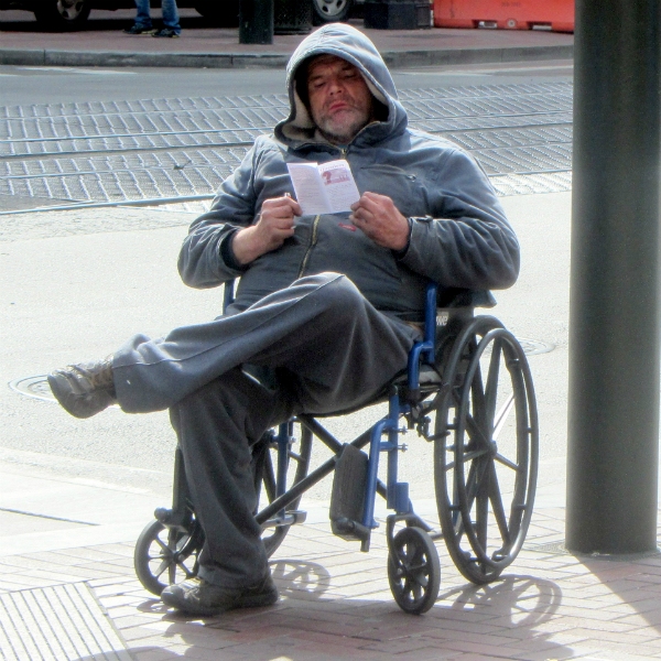 MAN READS TRACT AT 5TH AND MARKET ST