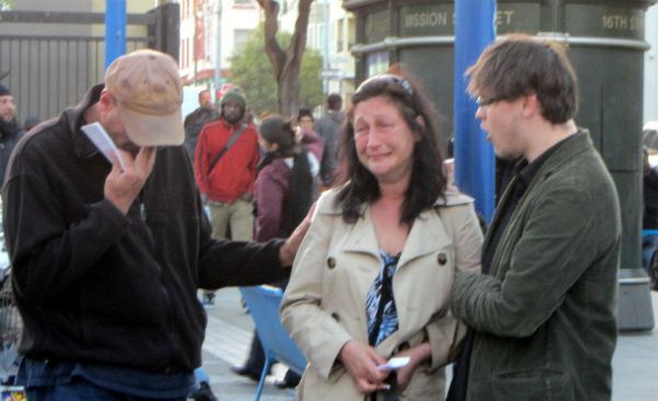 Alan and Shane pray with Cathy at 16th St. & Mission.