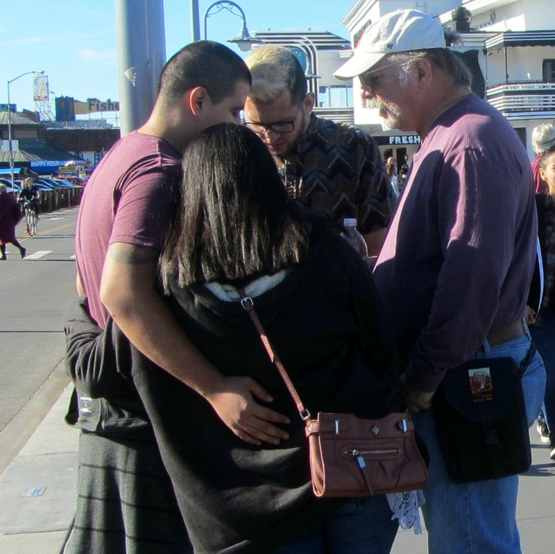 JACOB AND STEVE PRAY WITH COUPLE AT 5TH AND MARKET.