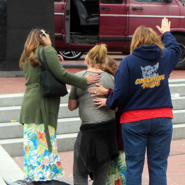 PRAYING FOR WOMAN AT UN PLAZA