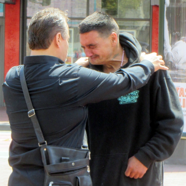 PAUL COCA PRAYS WITH MAN AT UN PLAZA