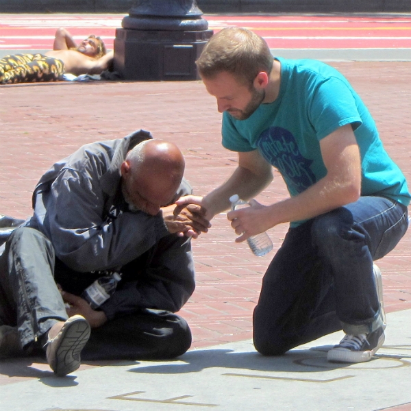 CAL PRAYS FOR MAN AT UN PLAZA.